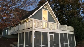 A two-story house with a balcony and a covered porch area. - Perfect Location For Your Lake Getaway (Cadiz)