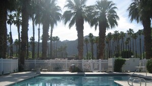 A swimming pool with a clear view of palm trees and mountains in the background. - Charming and Contemporary 5 Star PGA West Condo Stadium on11th Tee Box Lic100888 (La Quinta)
