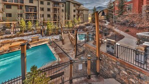 A multi-story hotel with outdoor swimming pools, a covered patio area, and a view of mountains. - Large Ski In Ski Out 3 Bedroom+Loft Sleeps 10 Pool Hot Tub Vaulted Ceilings MC10 B (Park City)