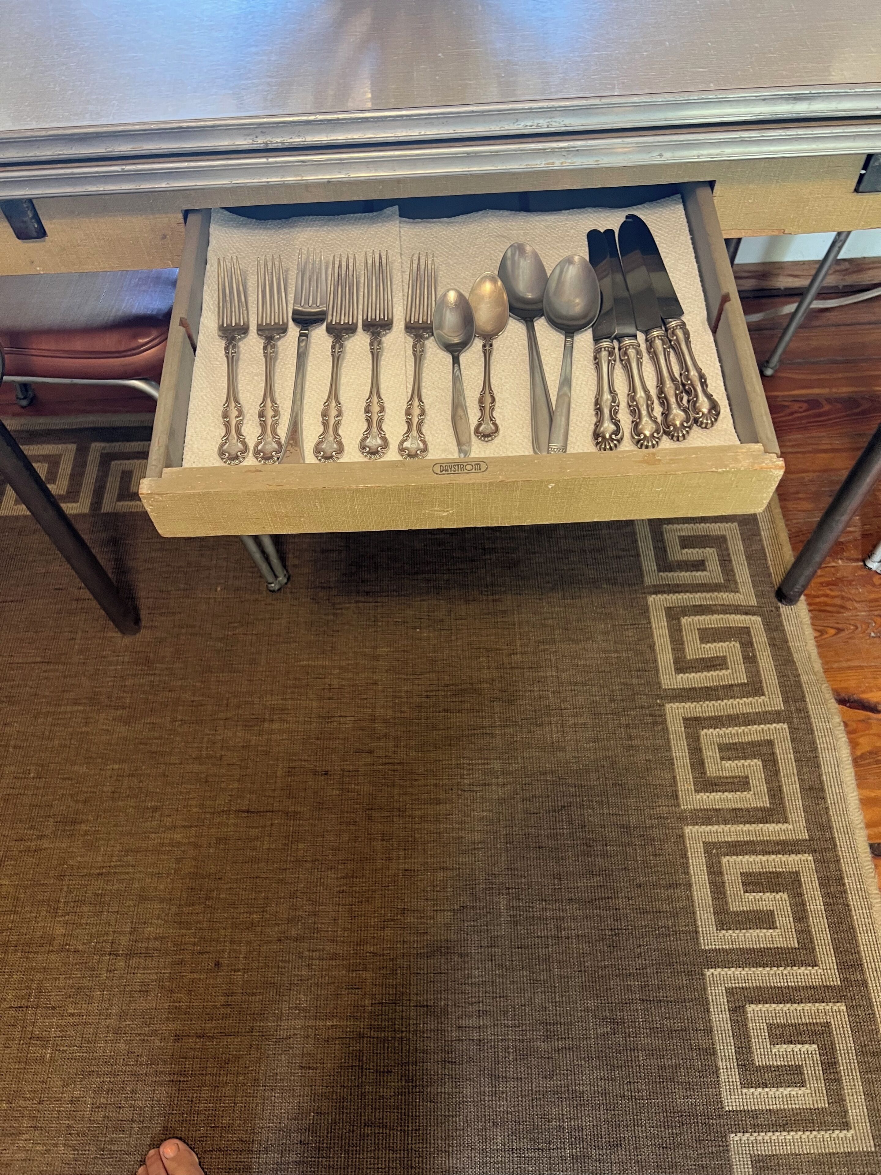 A drawer with silverware neatly arranged.