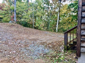 Escape to a cozy cabin nestled in the heart of the forest, surrounded by trees with vibrant autumn foliage.