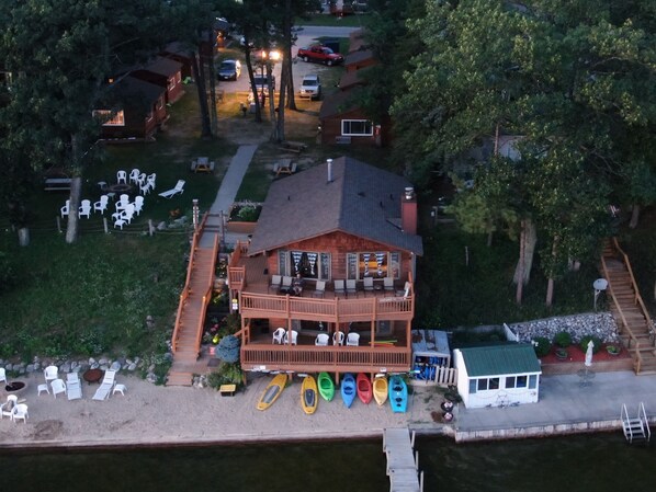 A lodge with a deck, kayaks, and a dock. - Waterfront home on Fife Lake (Fife Lake)