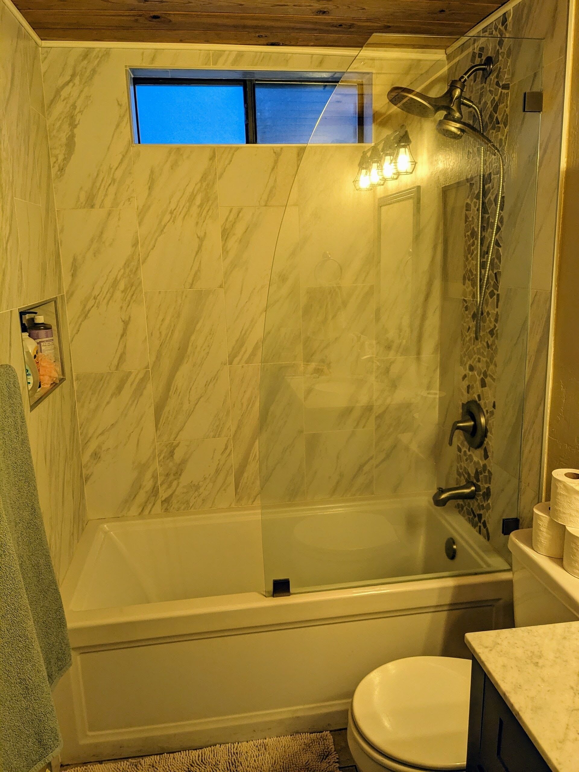 A bathroom with a bathtub, a shower, and a toilet.