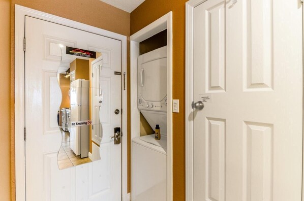 A hotel room with a white door, a laundry area, and a no-smoking sign. - Beach Lovers , and Divers Paradise, with a great Night life..... (Navarre)
