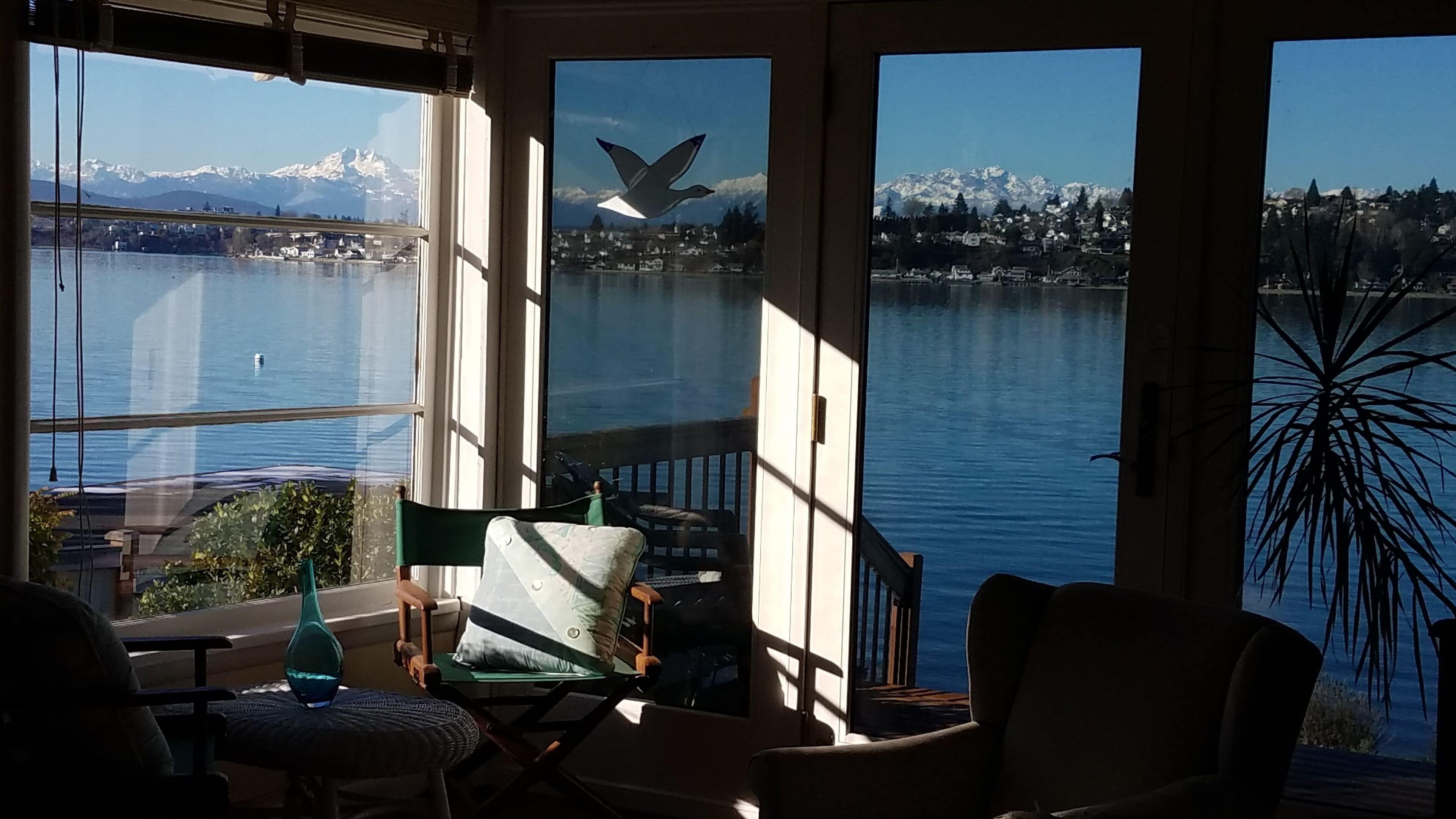 Large windows and 3 panel glass door to deck capture full views from Living Room