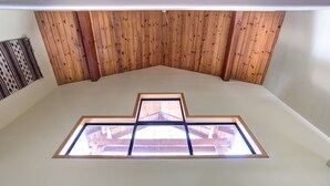 A room with a sloped ceiling and a skylight. - (12) Cabin Twelve at The Redwoods In Yosemite (Wawona)