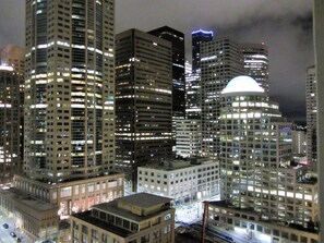 A nighttime cityscape with high-rise buildings, including a prominent building with a dome-like structure. - Extra Large 2-bdrm, 2 bath at Harbor Steps - Walk to Pike Place, Waterfront! (Seattle)