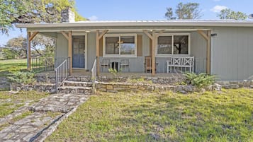 Relax on the covered porch, sheltered from the elements, and enter through the decorative metal grille.