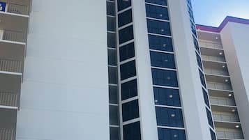 A multi-story building with a white facade and a purple accent.