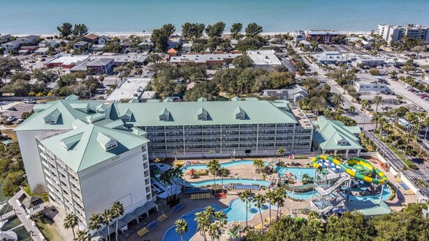 A hotel with a large pool area, including a water slide and multiple swimming pools. - Condo with Breathtaking Views on Water Park & 4 Free Passes, 4min Walk to Beach (Indian Rocks Beach)