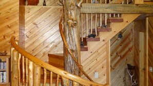 A wooden staircase with a natural wood finish, built into a log cabin interior with wooden walls and a sloped ceiling. - Red Blanket Cabin Near Crater Lake National Park (Prospect)