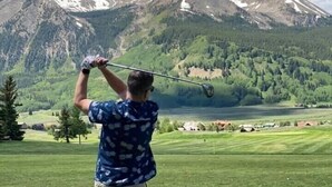 A person playing golf on a well-maintained course with a scenic mountain backdrop. - 5250 Sq Ft. 5-Star Mountain Home with 360° Peak & Valley Views (Crested Butte)