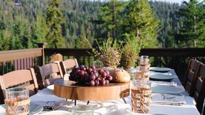 Un tavolo da pranzo all'aperto con vista su una foresta.