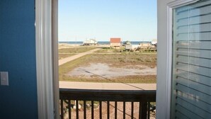 A view from a window with a view of a beach and buildings in the distance. - Spacious 4 B/R 3 BA - best of both - Bay and Gulf  (Surfside)