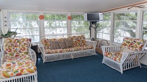 Relax in a cozy seating area with a sofa, chairs, and flat-screen TV.