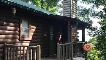 Step into this charming cabin with a cozy porch and a warm fireplace.