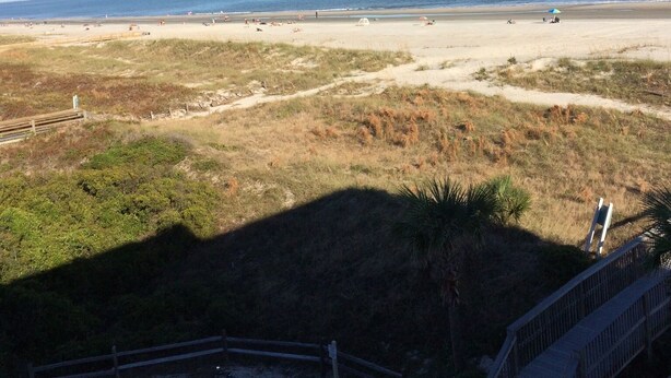 A beach with a wooden fence and a bike path leading to the shore. - HHI Beach & Tennis #AR416, 2BR2BA, top 4th fl, angled Oceanfront condo, 6 max. (Hilton Head Island)