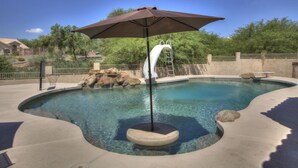A swimming pool with a diving board, a ladder, and a basketball hoop. - 4 Bedroom Single Story Golf Course Home, Heated Diving Pool + Slide, & Hot Tub  (Phoenix)