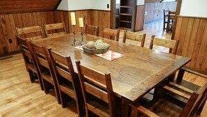 A wooden dining table with chairs, candles, and a decorative centerpiece. - Westcott House- Privacy, amenities and space all in one beautiful package! (Luray)