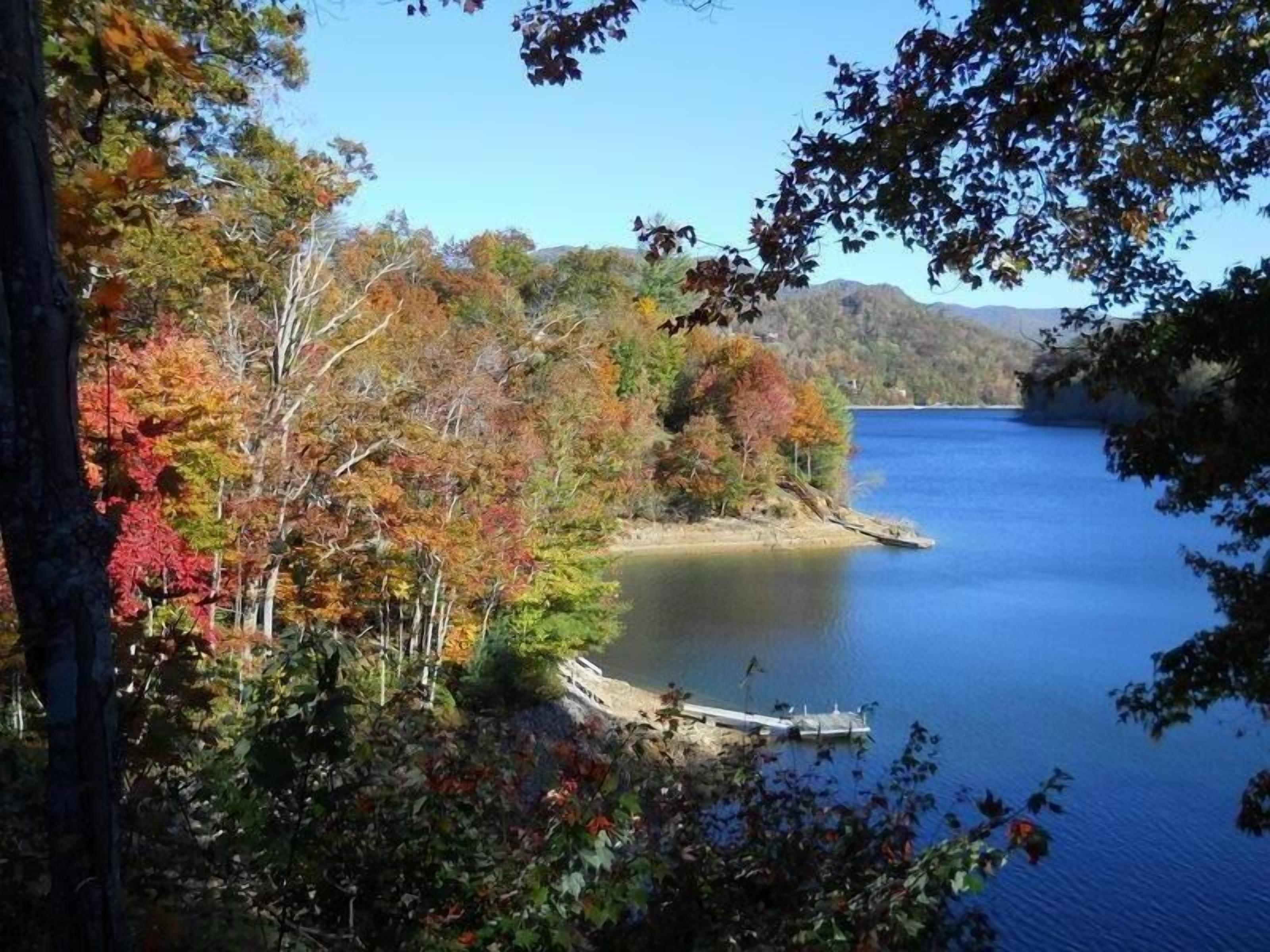A serene lake surrounded by autumn foliage.
