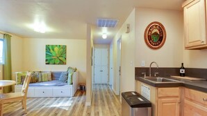 A compact living space with a kitchenette, a dining area, and a bedroom. - The Cascade River Trail Retreat - a short walk to river & downtown! Pets OK! (Bend)