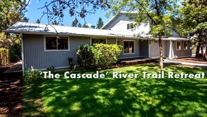 A single-story house with a sloped roof, a front porch, and a well-maintained lawn. - The Cascade River Trail Retreat - a short walk to river & downtown! Pets OK! (Bend)