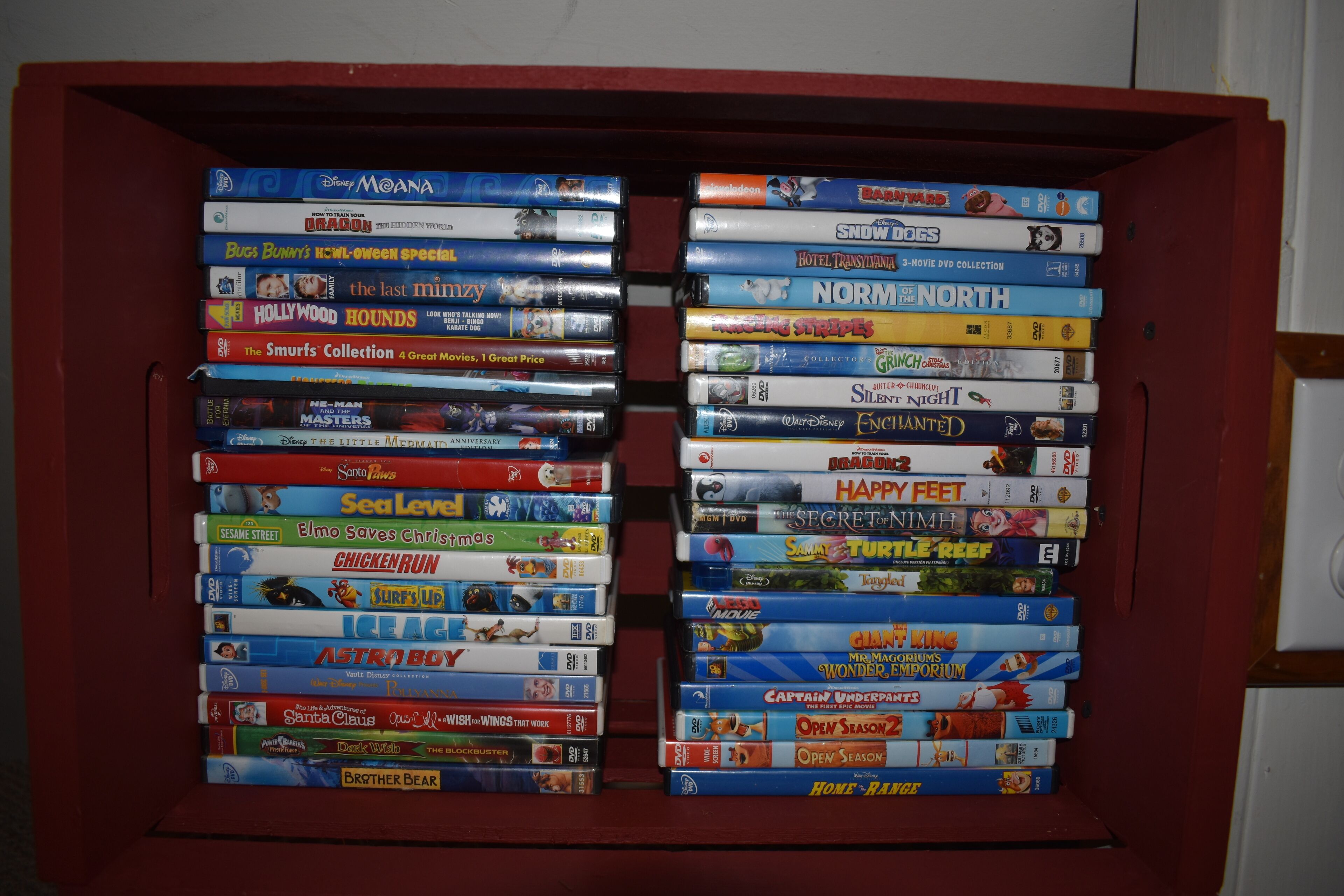 A DVD shelf with various movie titles.