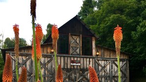 A rustic wooden building with a sign that reads "Hunter's Lodge."