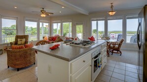 A spacious kitchen with a central island, large windows, and a view of the outdoors. - Vacation Paradise! Awesome Waterfront Home, Unbelievable View Of Stump Sound! (Surf City)
