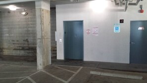 A parking garage with two doors, a reserved parking sign, and a tow warning sign. - MBV 6Br/5Ba - 302B (Myrtle Beach)