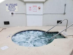 A hot tub with a sign indicating no lifeguard on duty and a warning about maximum occupancy. - MBV 6Br/5Ba - 302B (Myrtle Beach)