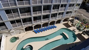 A hotel with a pool area, including a large pool and lounge chairs. - MBV 6Br/5Ba - 302B (Myrtle Beach)