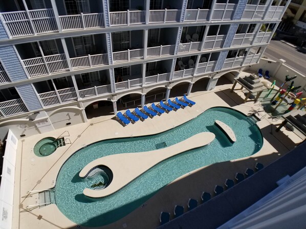 A hotel with a pool area, including a large pool and lounge chairs. - MBV 6Br/5Ba - 302B (Myrtle Beach)