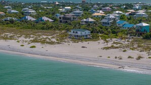 A coastal residential area with houses surrounded by greenery and a beach. - Beach's Edge, On the beach (Captiva)