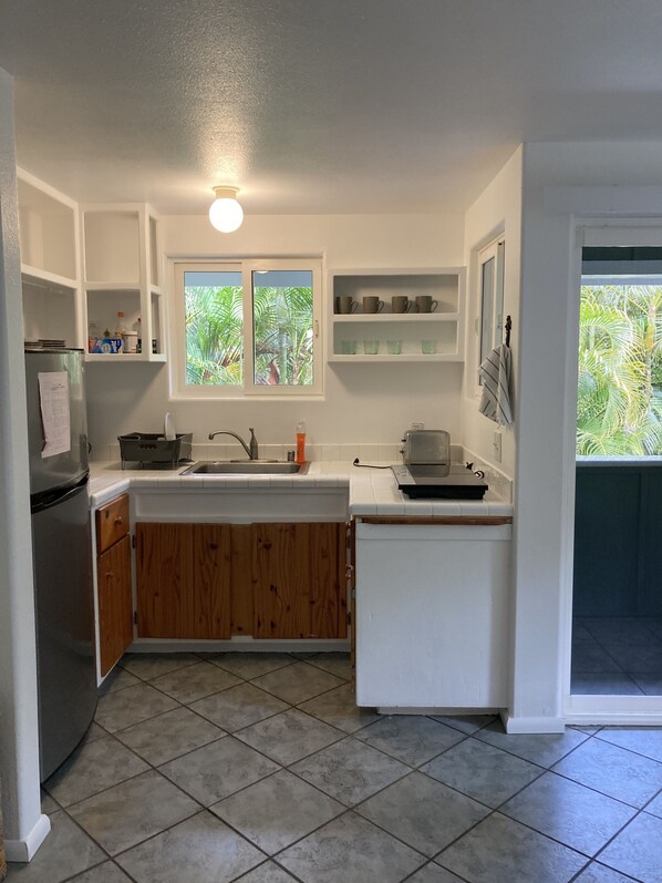 Fridge, microwave, coffee/tea maker, cookware/dishes/utensils