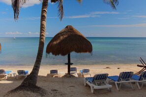 On the beach, sun-loungers