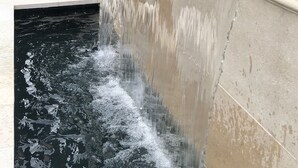 A water feature with a stone basin and a waterfall. - Romantic Guest House, Spectacular Views, Close to everything , Private Hot Tub (San Diego)