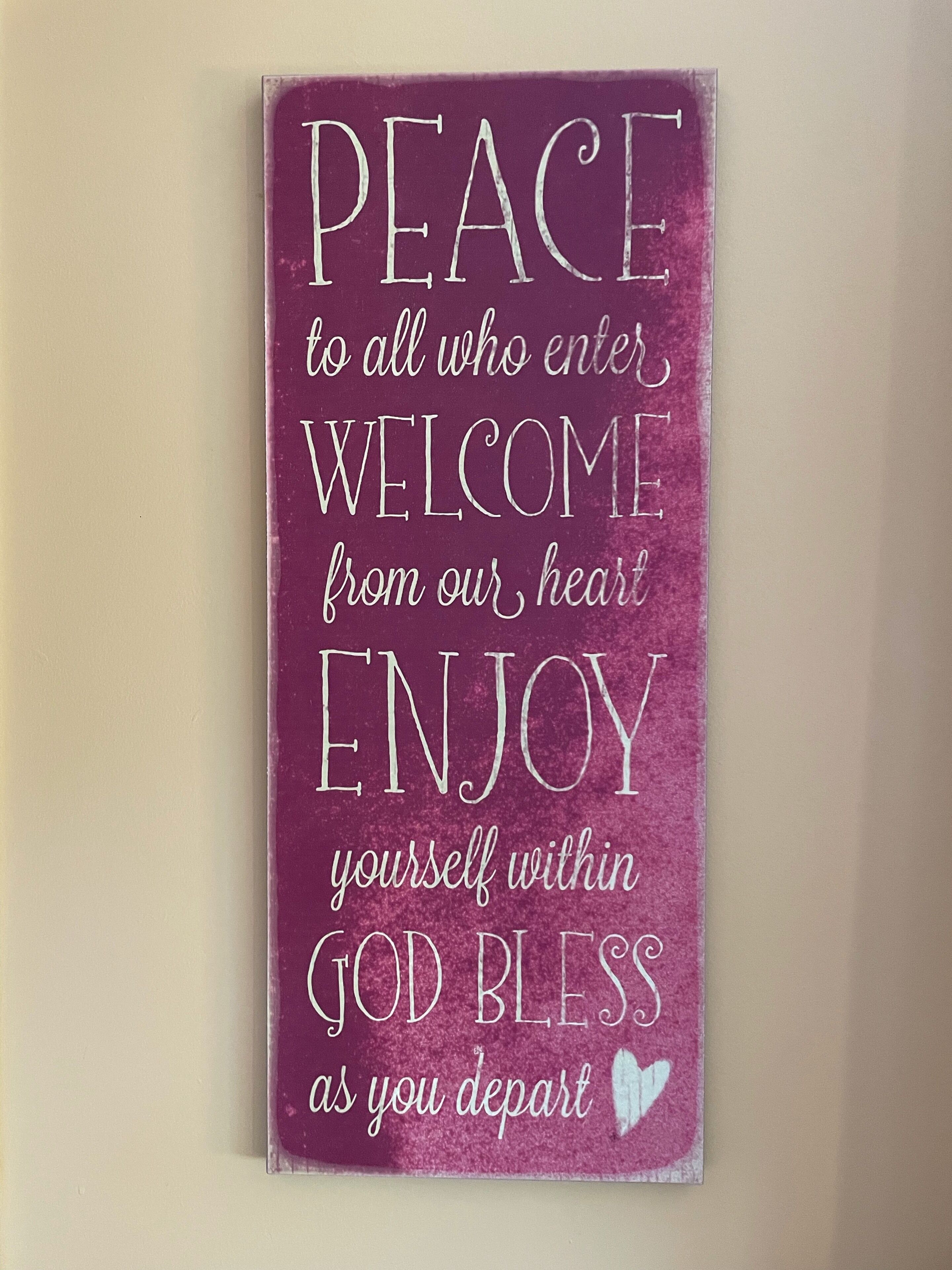 A sign with a message of welcome and peace.