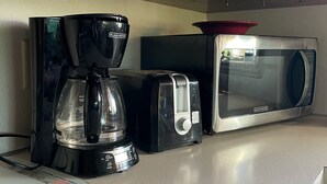 A kitchen with a coffee maker, toaster, and microwave on the counter. - Scenic View Lodging ~ A Country Suite with Country Charm. (Gap)