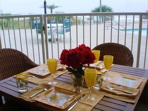 Enjoy a romantic dinner for two under the stars, with a pool and palm trees in view.