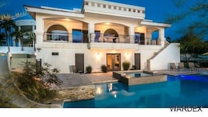 A modern two-story house with a swimming pool, large windows, and a balcony. - Luxury Estate in Prime Location w Panoramic views of Lake Havasu (Lake Havasu City)
