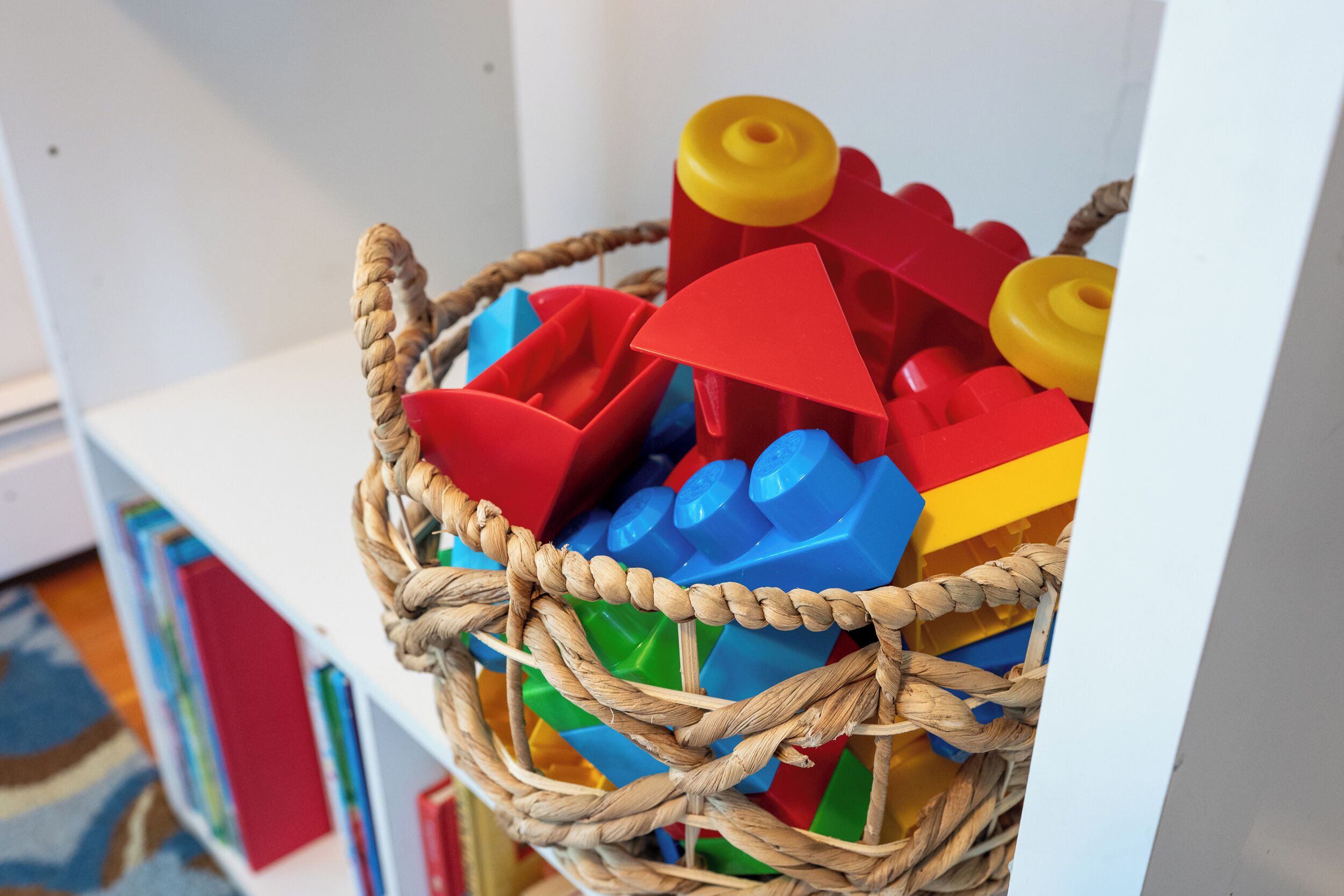A basket filled with colorful building blocks.