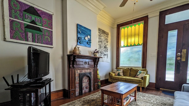 A living room with a fireplace, a television, a sofa, and a coffee table.