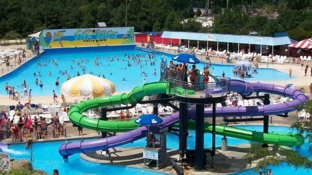 A water park with multiple slides and a large swimming pool. - Highly rated, clean, ground floor condo w/pool; steps to beach. (Virginia Beach)