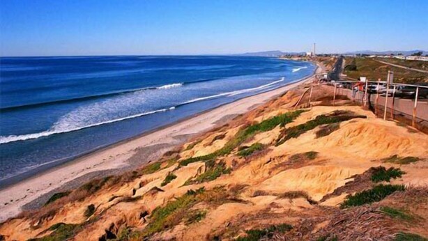 A coastal landscape with a sandy beach and rocky cliffs. - Family Friendly Beach House - Rare Central Air Conditioning, Close to Town/Beach (Carlsbad)