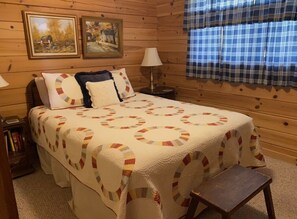 A cozy bedroom with a large bed, a bedside table, a lamp, and a window with plaid curtains. - The Perch, Fantastic Mtn Lake View! Very clean, Dogs Welcome. (Hiawassee)