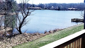 A lake with a wooden deck in the foreground. - Lake Front unit ready 4 you!  - sleeps 12 in beds, w/king bed, WiFi, pets (Crossville)