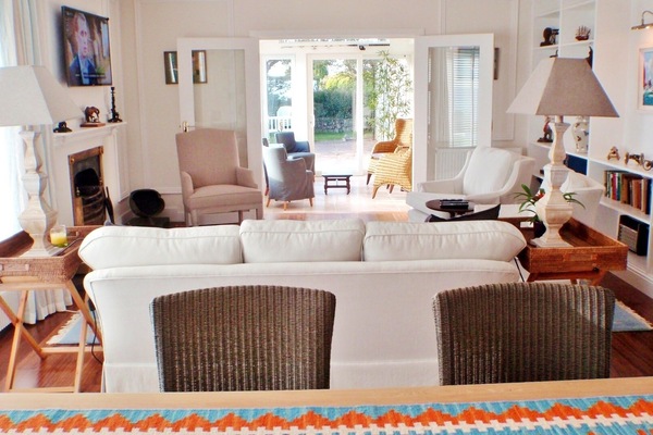 Cozy living room looking out to the sunroom fireplace is decorative Non-working