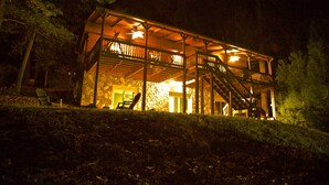A two-story wooden cabin with a balcony, stairs, and a stone wall entrance. - Clemson Football- Lake Hartwell Lakefront Cabin Private Dock 4 BR (Fair Play)