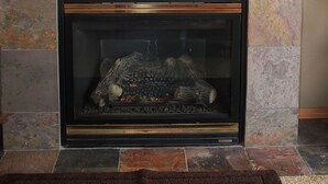 A fireplace with a TV mounted above it. - Golden Escape- Private Hot tub, Dog Friendly (Redmond)
